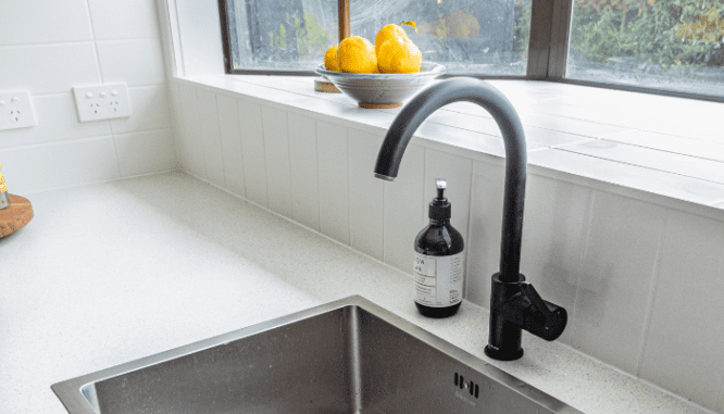 A faucet in a kitchen that has been updated.