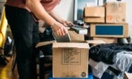 a person packs boxes to see if they can afford to move out