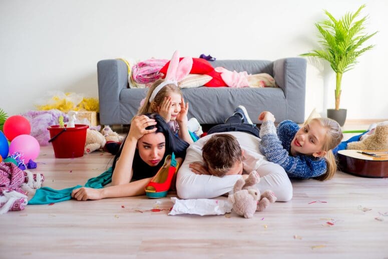 A group of kids with a mother trying to stage their messy home.