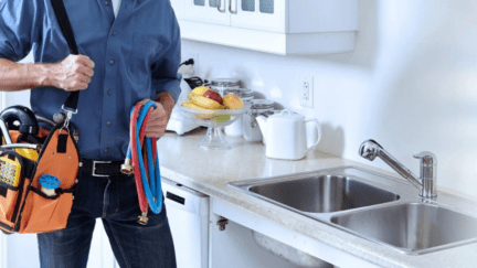 Image of a home repair contractor making repairs to a house