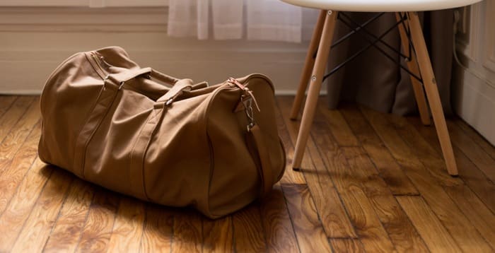 A bag packed with overnight clothes during a home move.