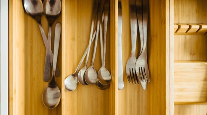 Cutlery in a drawer that will have plastic wrap on it to smooth out a home move.