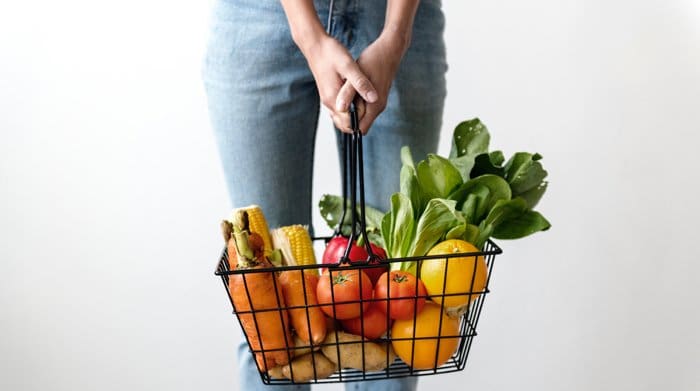 A woman with groceries who remembered to buy after moving.