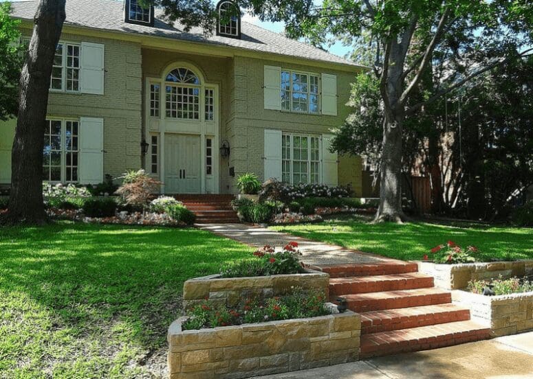 Split-level house with landscaping in front to create curb appeal.