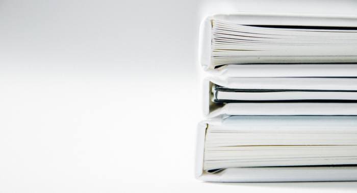 HOA documents in white binders.