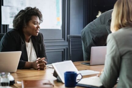 Meeting with two professionals discussing disclosures in real property transactions.
