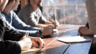 Men meeting at table to review HOA documents.