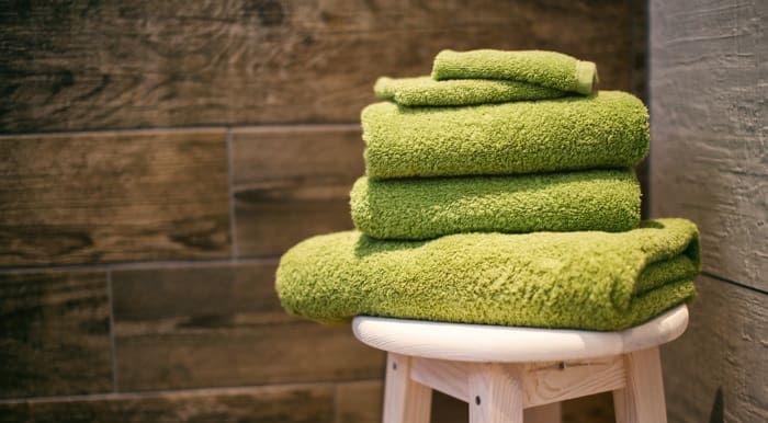 Green towels in bathroom to give soft home staging on lost cost.