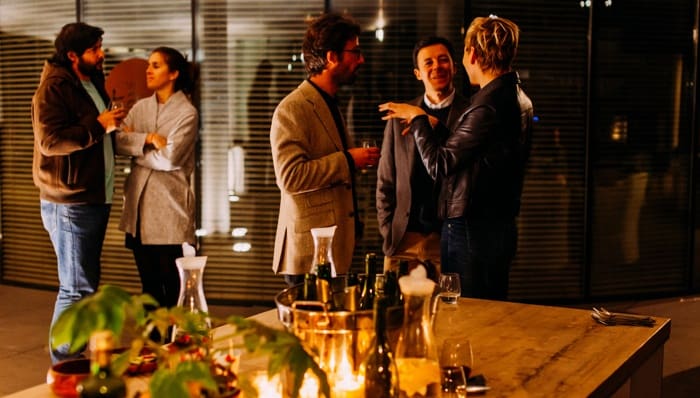 Brokers chatting in house during open house event.