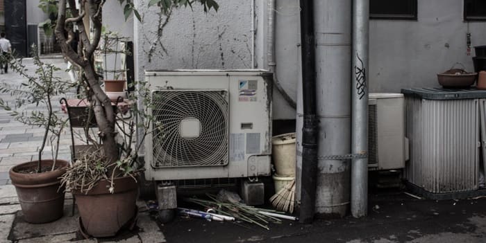 Old air conditioning unit outside of home.