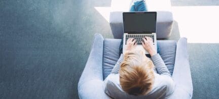 A man using a laptop to list a home for sale.