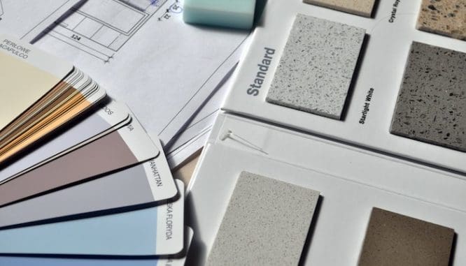 Swatches of paint and countertop material samples for a fix-and-flip, one method of real estate investing