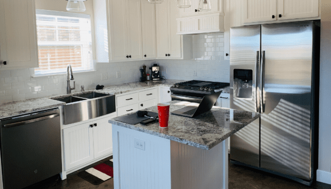 A kitchen with stainless steel appliances in it.