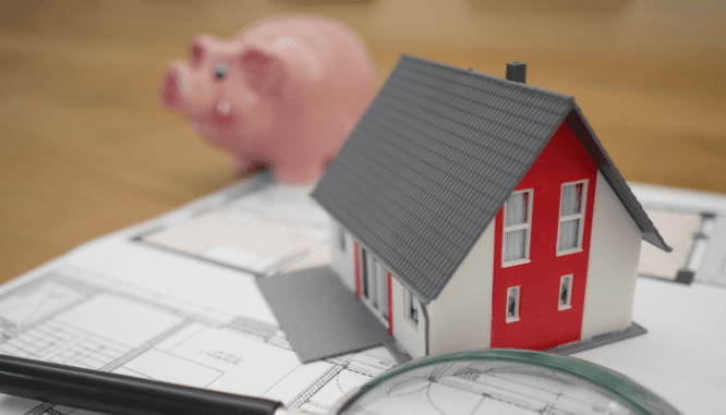 A house on a floor layout with a piggy bank.