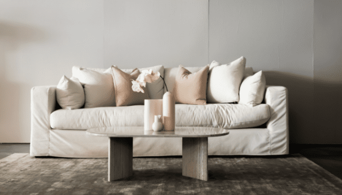 A couch in home that a real estate agent sold.