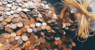 A jar of coins tipped over to be used for a home appraisal cost.