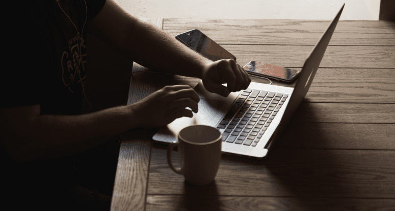 A homebuyer using a computer to hire a real estate agent.