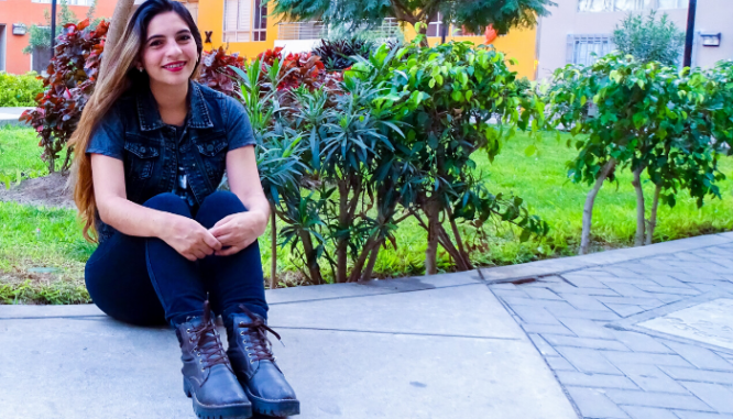 A woman with some fledgling trees that will increase property value.