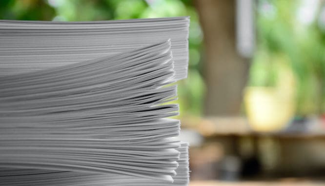 A stack of documents to symbolize getting your documents in order while buying a house during coronavirus