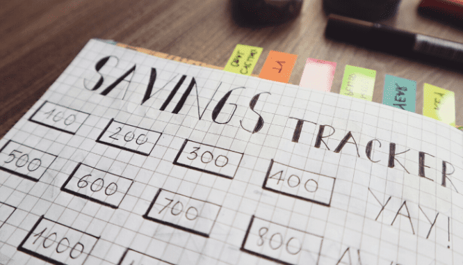 A close-up of a savings tracker notebook in order to budget for home maintenance.