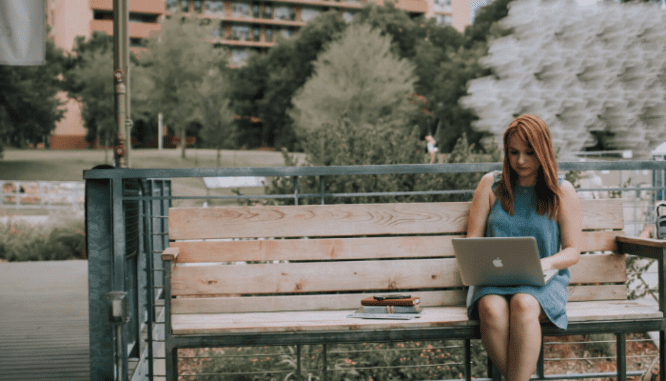 A woman using a computer to predict the housing market in 2021.