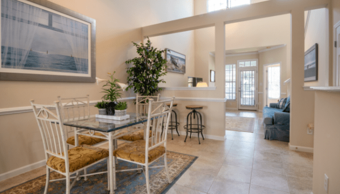 The interior of a dining room and a living room.