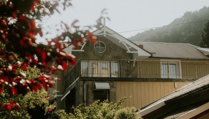 A home with a balcony that is slightly damaged.