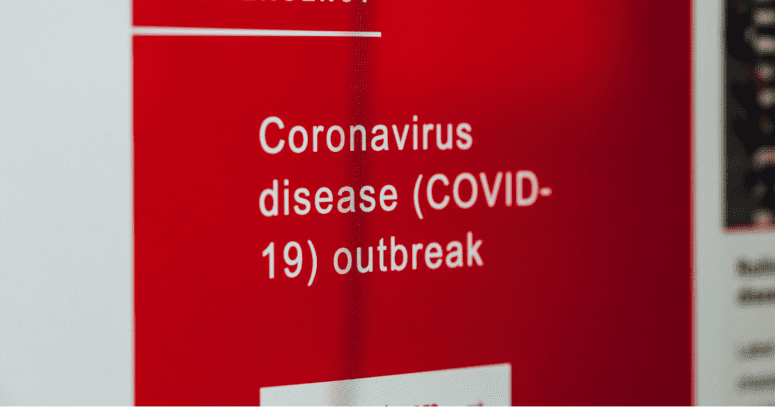 A red sign that reads "Coronavirus diease (COVID-19) outbreak."