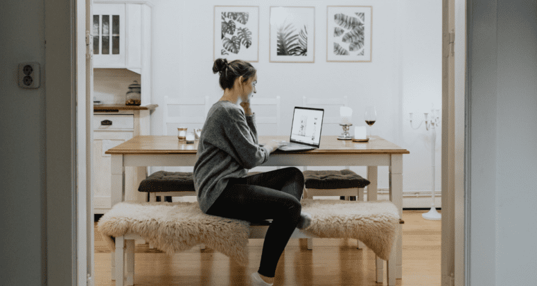 A woman reading tips for selling a home during coronavirus.