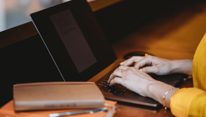 A woman using a computer to sell a home during coronavirus.