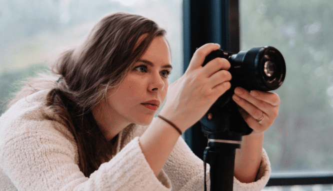 A person with a camera during a virtual open house.