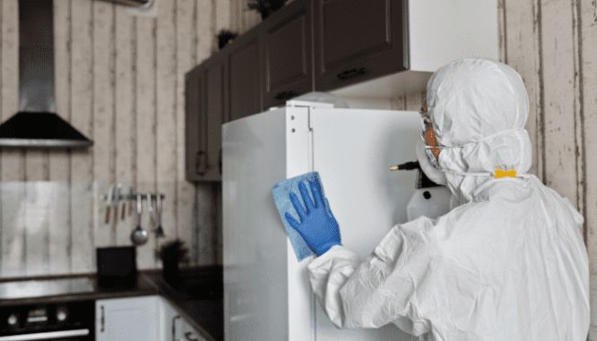 A person cleaning a house because of a coronavirus clause.