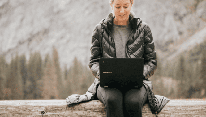 A woman using a computer to get down payment assistance during coronavirus.