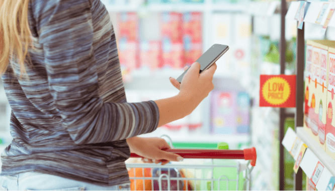 Someone using a smart phone to look up coupons in order to save money when moving into a new house