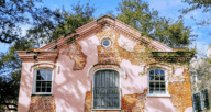 A red brick house with pink plaster spots still left on top you could be packing to move into.