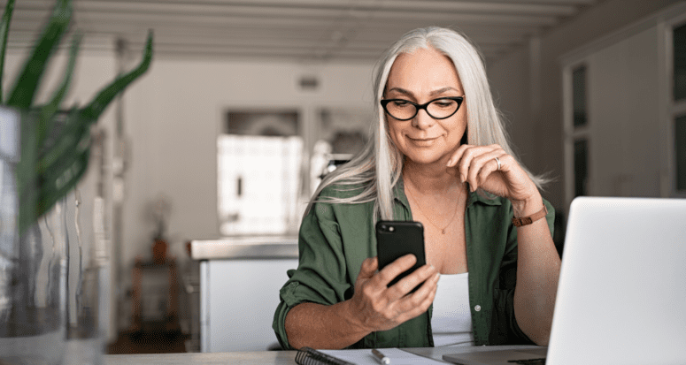 A woman looking at a phone during a home sale.