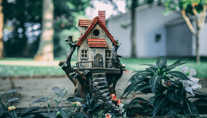 A birdhouse in a garden.