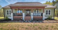 A full porch on a one-story house that could be at auction.