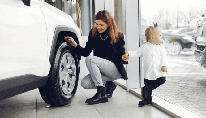 A woman with a young baby who is looking to buy a car to build credit without a credit card.