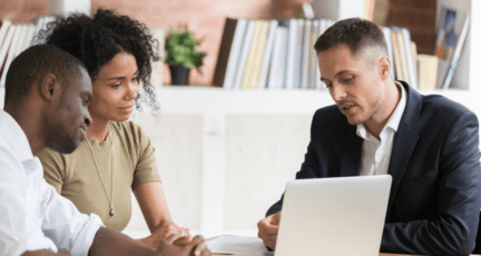 A listing agent meeting with a couple.