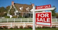 A short sale sign outside of a house for sale, kickstarting the short sale buying process