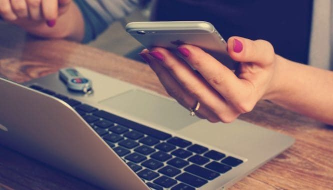 A woman getting ready to contact a lender via phone or computer as part of the short sale buying process