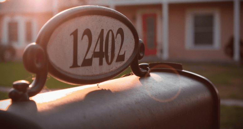 An address sign on top of a mailbox in the new home you're getting settled in.