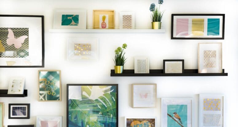 A wall of beautifully arranged art in a new house