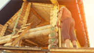 A man building a log house himself as part of a build your own house program