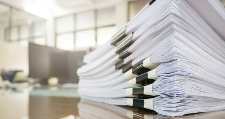 A stack of closing documents attached with binder clips