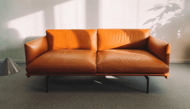 A burnt orange love seat, an example of optimizing the furniture arrangement in a new house.