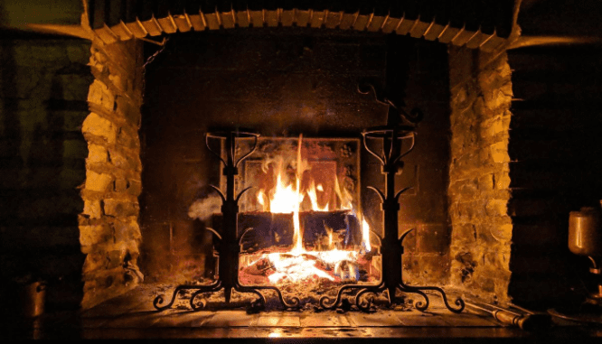 A photo of a fireplace illustrates the topic of common repairs needed after a home inspection.