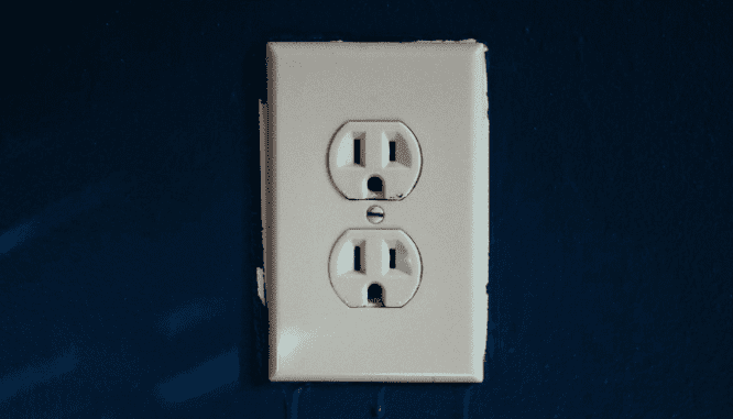 A photo of an electrical outlet illustrates the topic of common repairs needed after.a home inspection.