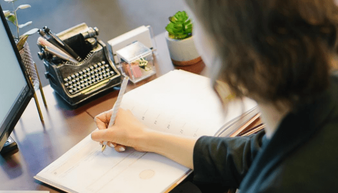 A photo of a woman working illustrates an executor's need for a lawyer or real estate agent.